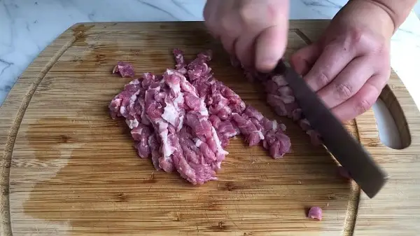 grinding meat with knife