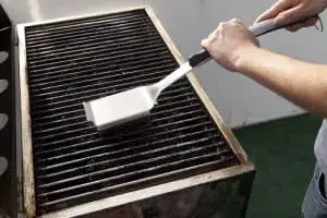 Cleaning a Grill using Wire Brush